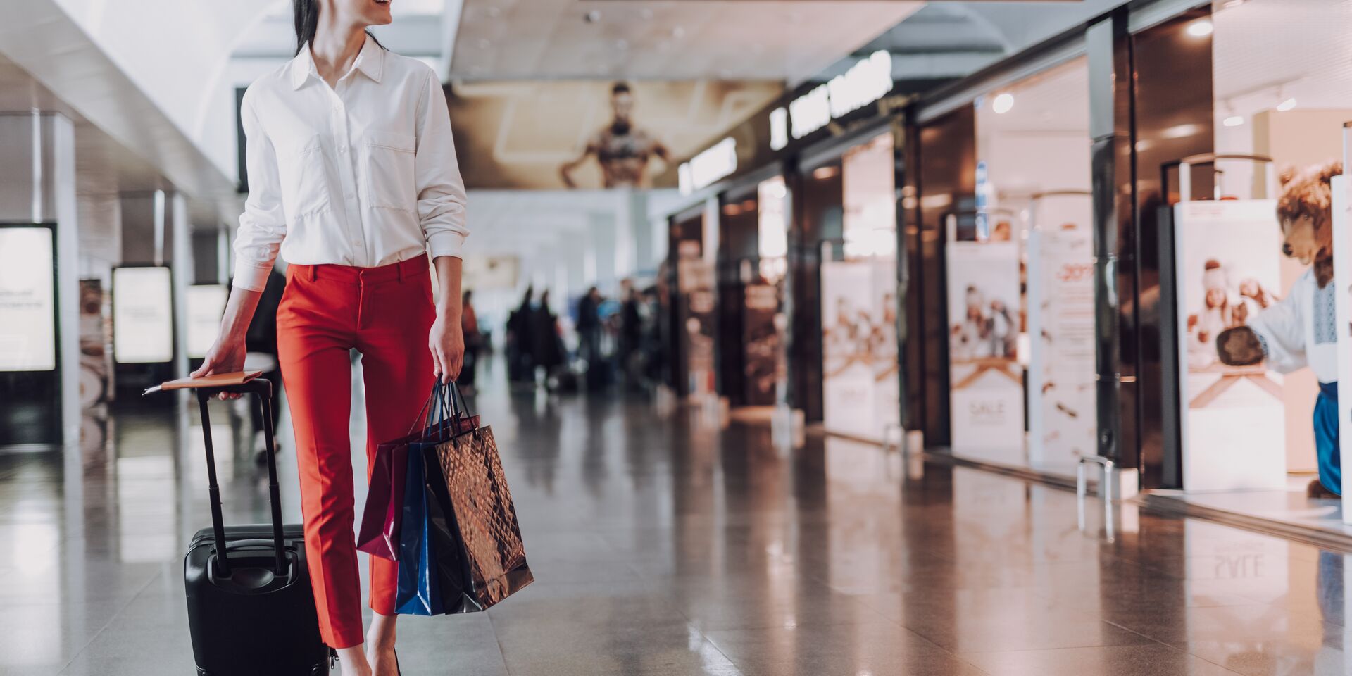 Woman walking in the airport with hand baggage