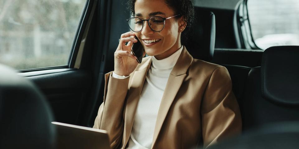  Businesswoman-working-inside-a-cab-on-the-way-to-work