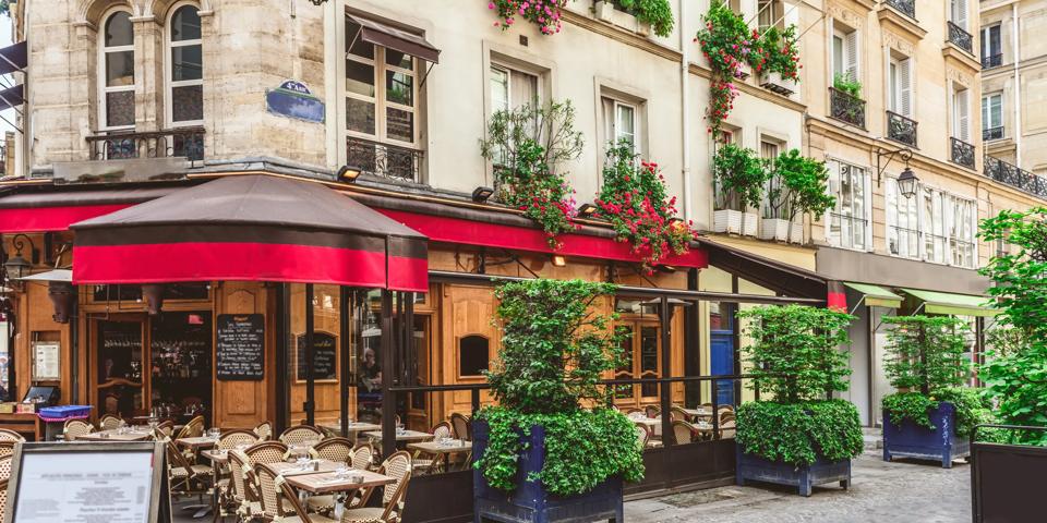 Typical view of the Parisian street with tables of brasserie (cafe) in Paris, France