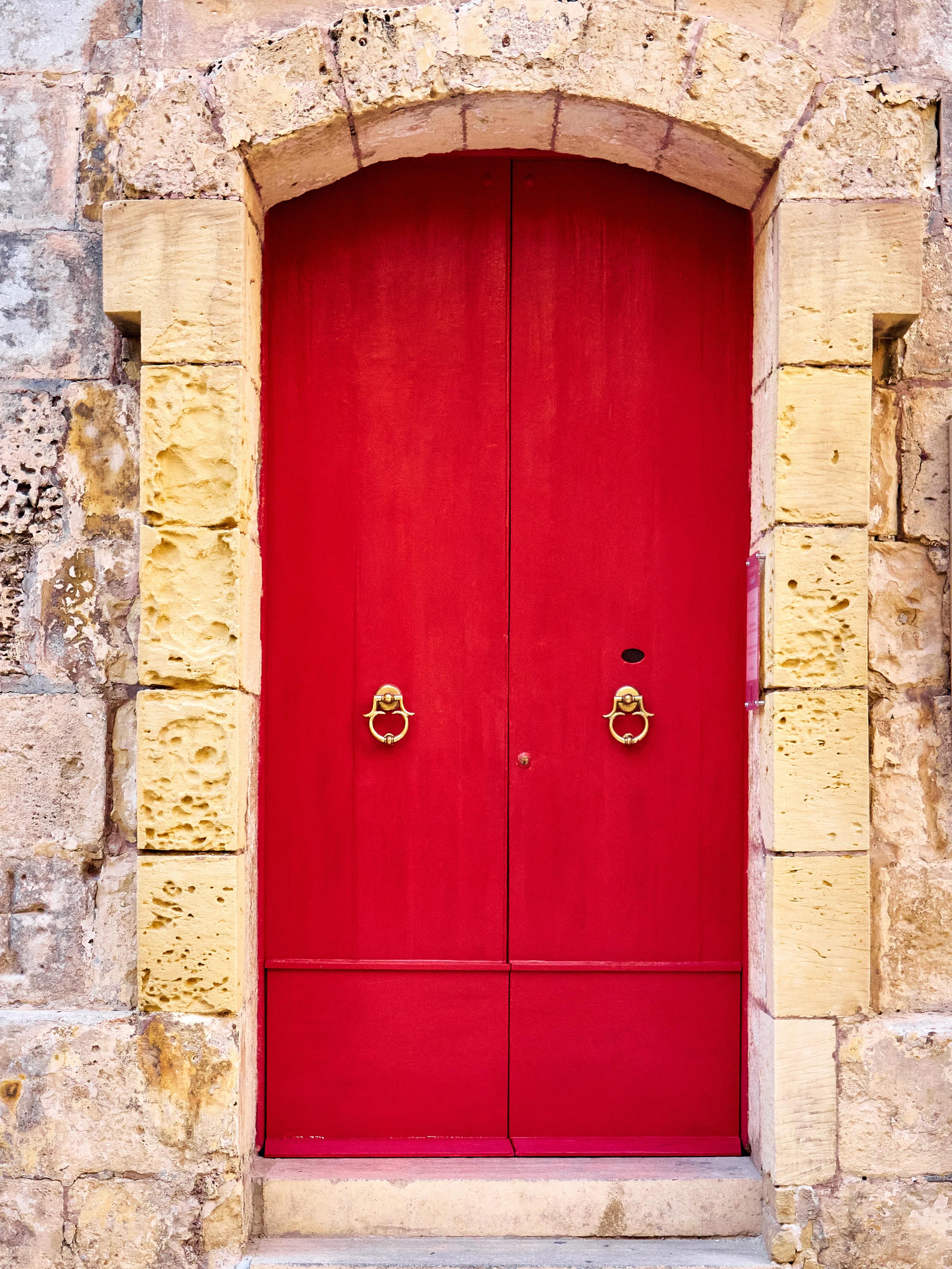 Red wooden door in the old town of Mdina, Malta