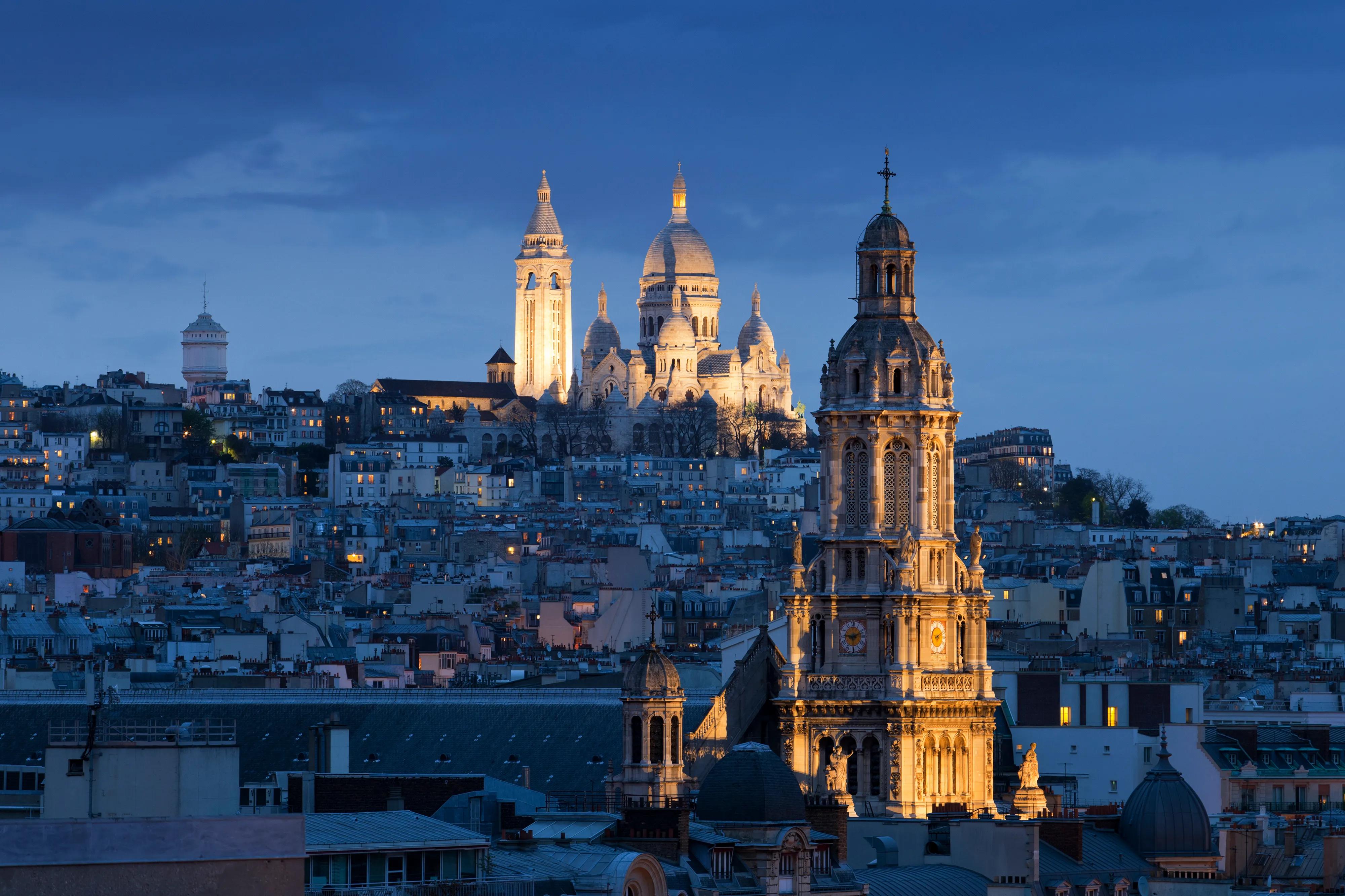 Sacre coeur (Basilica of Sacred heart), Montmartre and Sainte-Trinité at night, Paris, France