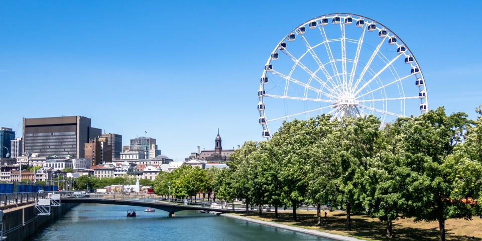 Montreal Ferris wheel in the Old port. La Grande Roue de Montreal. Montreal skyline in background.