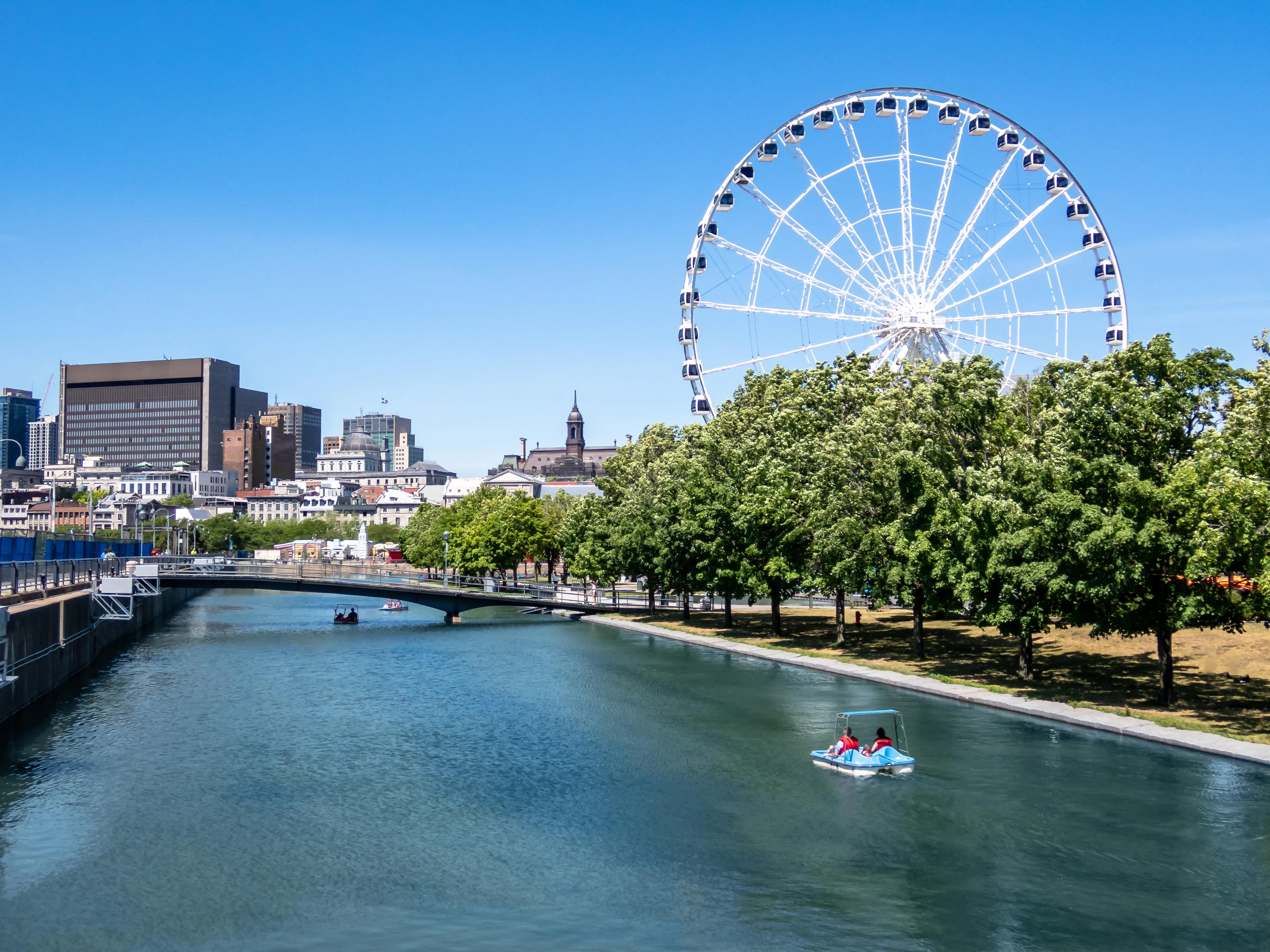 Montreal Ferris wheel in the Old port. La Grande Roue de Montreal. Montreal skyline in background.